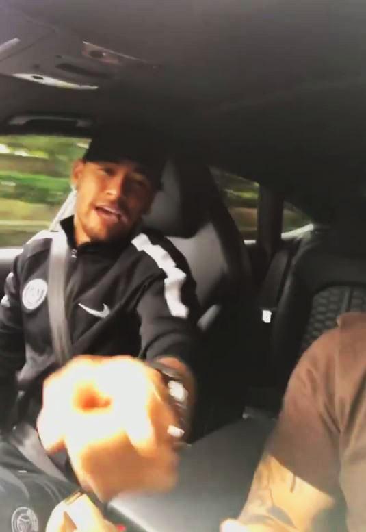  Neymar in the front of a car singing with a pal in Paris