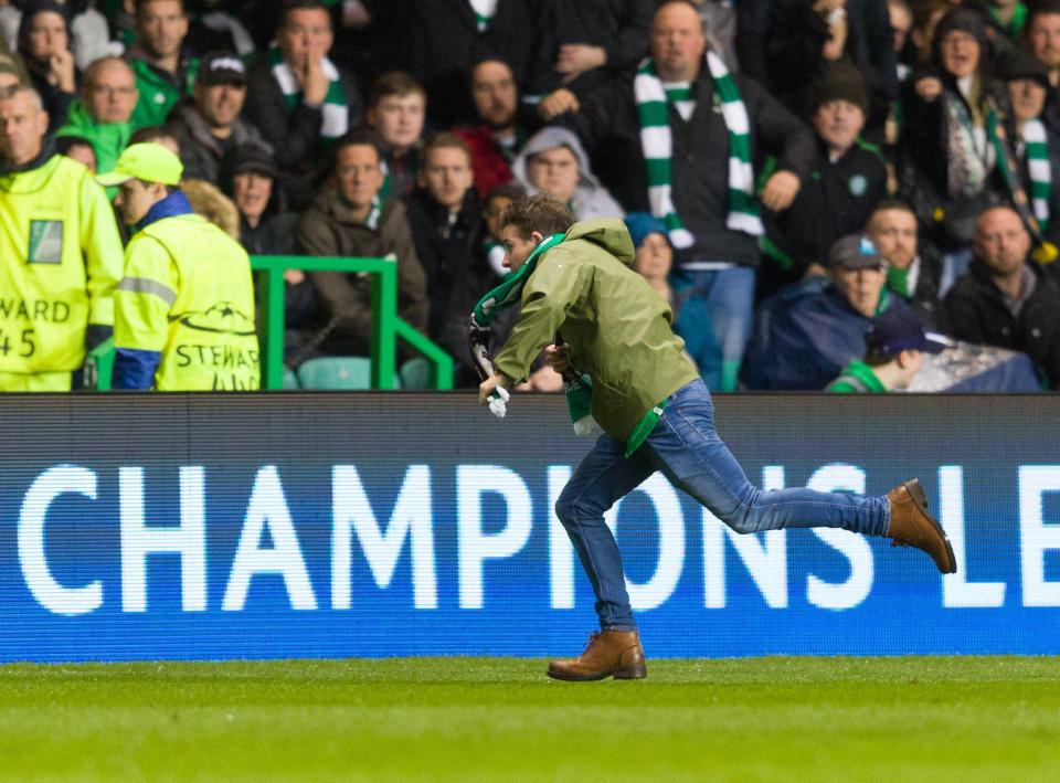  A Celtic fan runs around on the pitch during the Hoops' Champions League group stage tie against Paris Saint-Germain