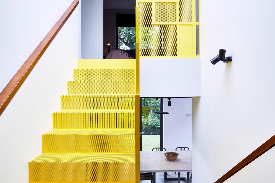 The house features a funky bright yellow steel staircase which is Penny's pride and joy