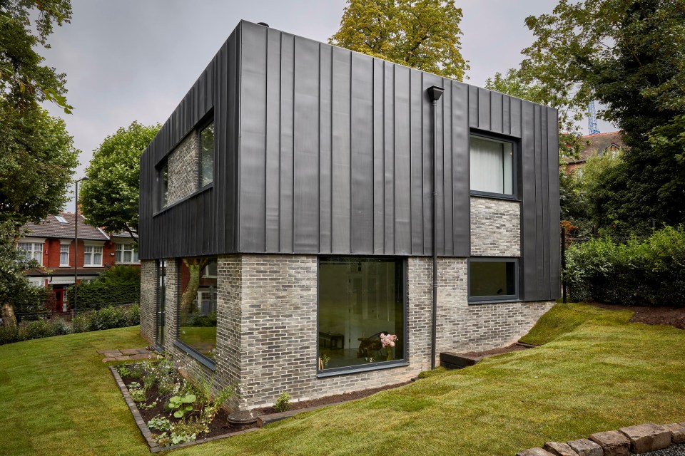 The couple's cube-shaped house features external zinc panelling