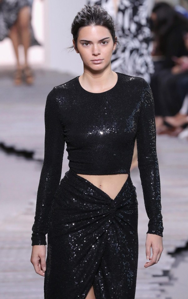 The model wore a black sparkly top and wrap skirt