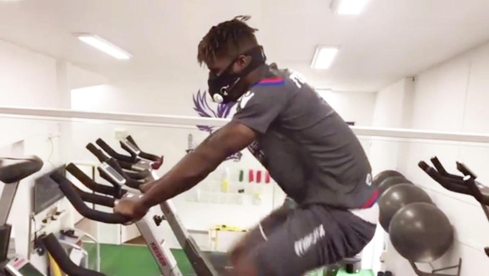  Wilfried Zaha dons an 'altitude' mask on his exercise bike while recovering from a knee injury