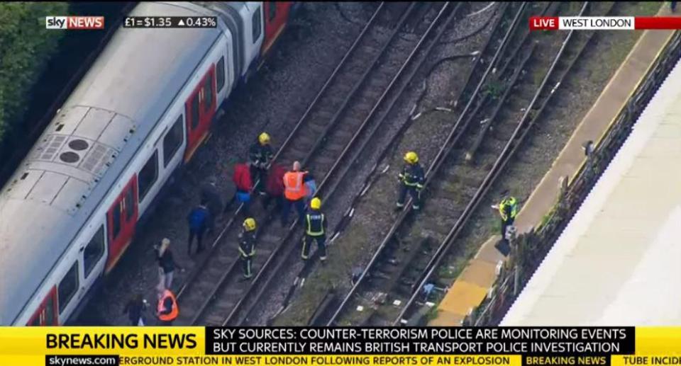  Emergency services on the tracks as the train was held in the station