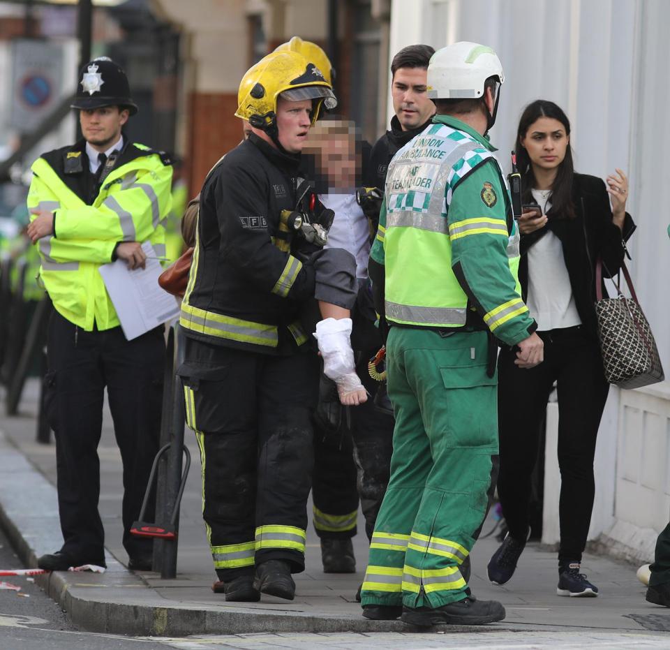  The boy is pictured being carried from the terrifying scene by firefighters