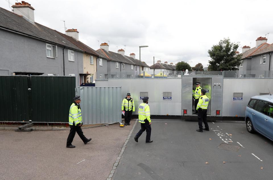  Cops guard a cordon around the property in Sunbury-on-Thames today