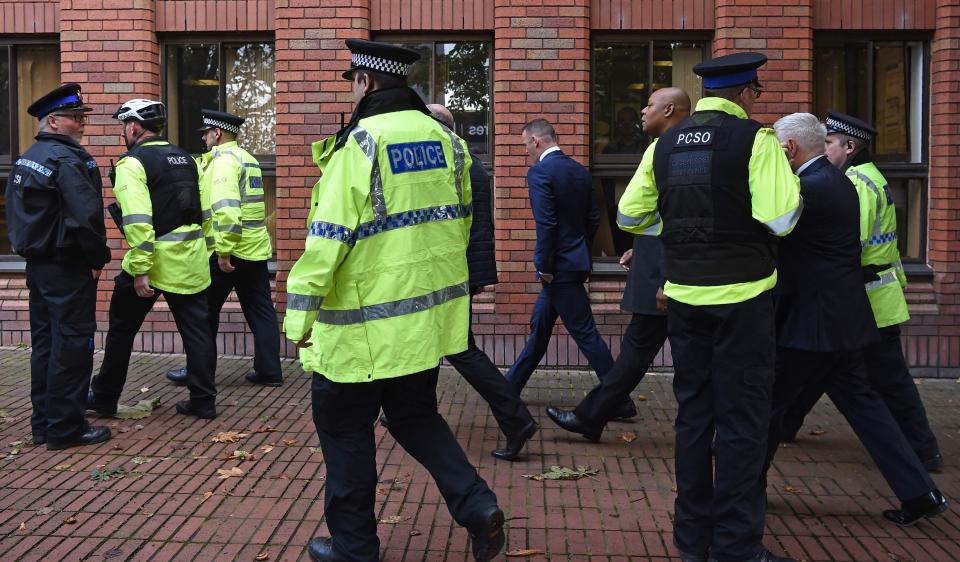  Half a dozen police officers were forced to escort Rooney into court