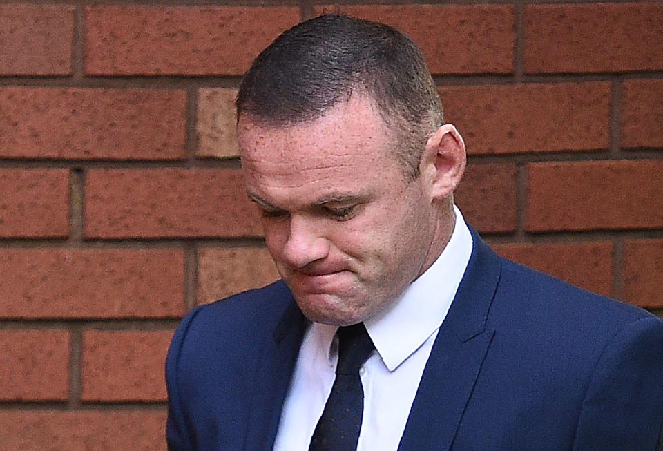  The former England star appears to grimace as he walked into court this morning