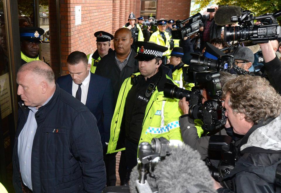  Wayne Rooney was flanked by police officers as he arrived at court to plead guilty for drink driving