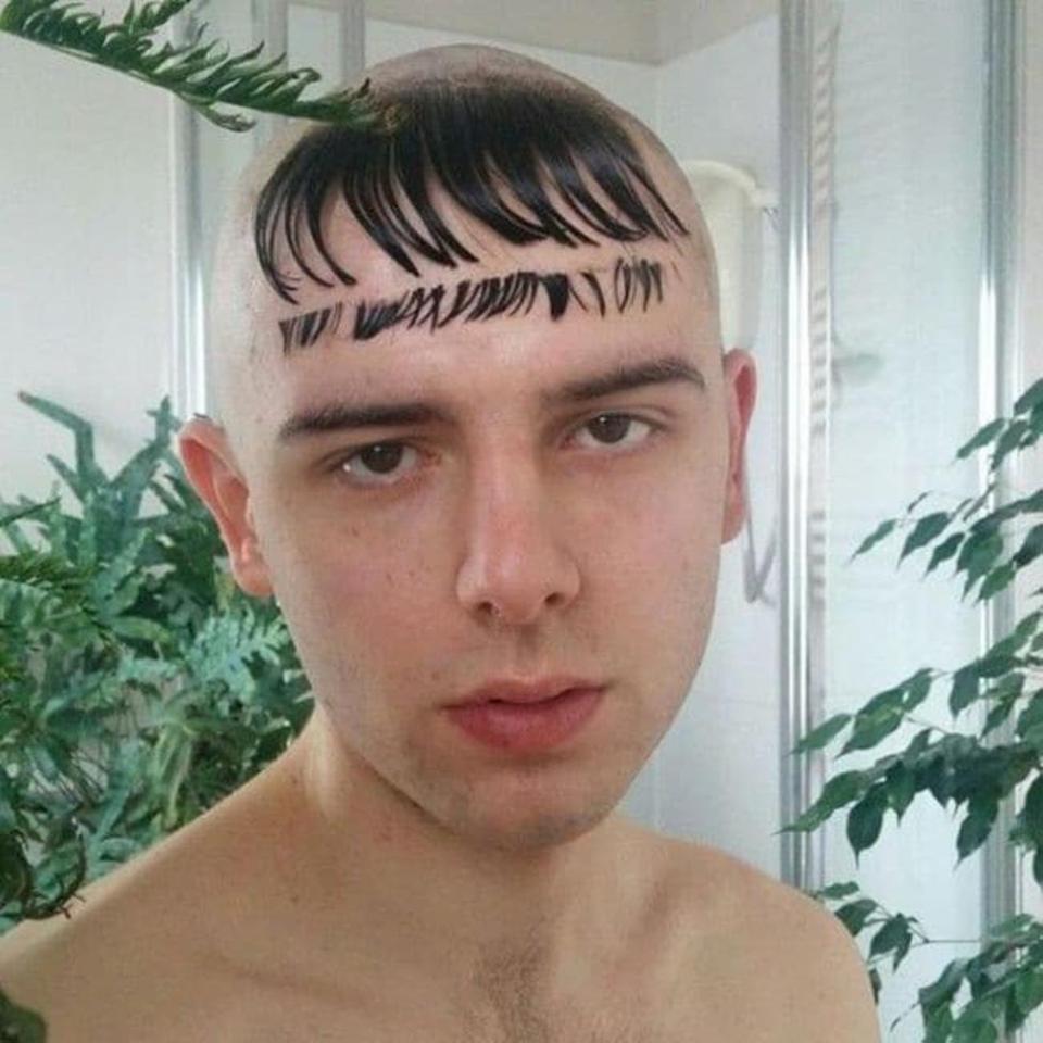  A man shows off his VERY dodgy hairstyle, which features a shaved head and a gelled-down fringe