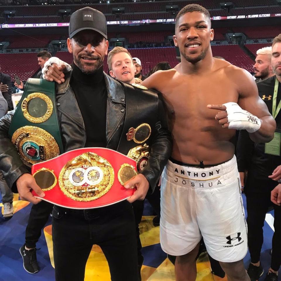  Rio Ferdinand stands with Anthony Joshua and the British heavyweight's world title belts