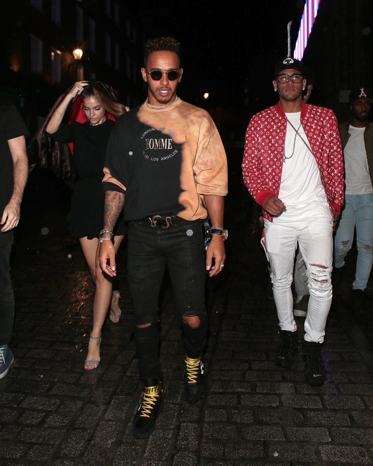 Barbara shields her head as she strolls between venues with Lewis and Neymar