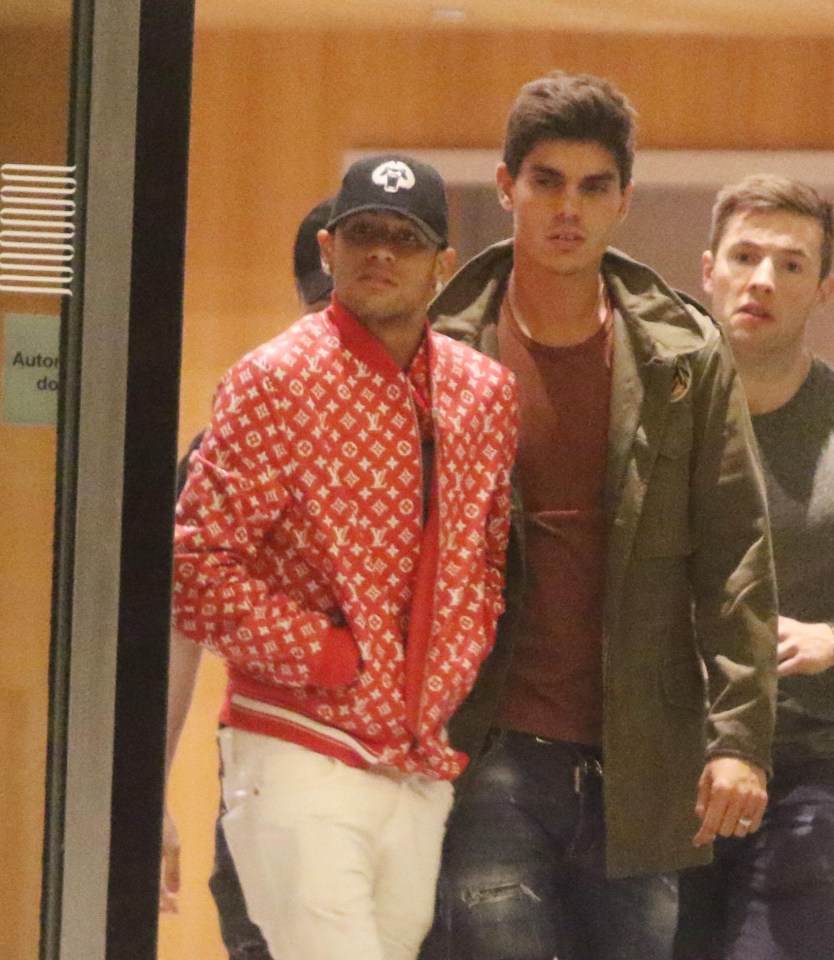 Neymar was snapped with male pals outside the flat