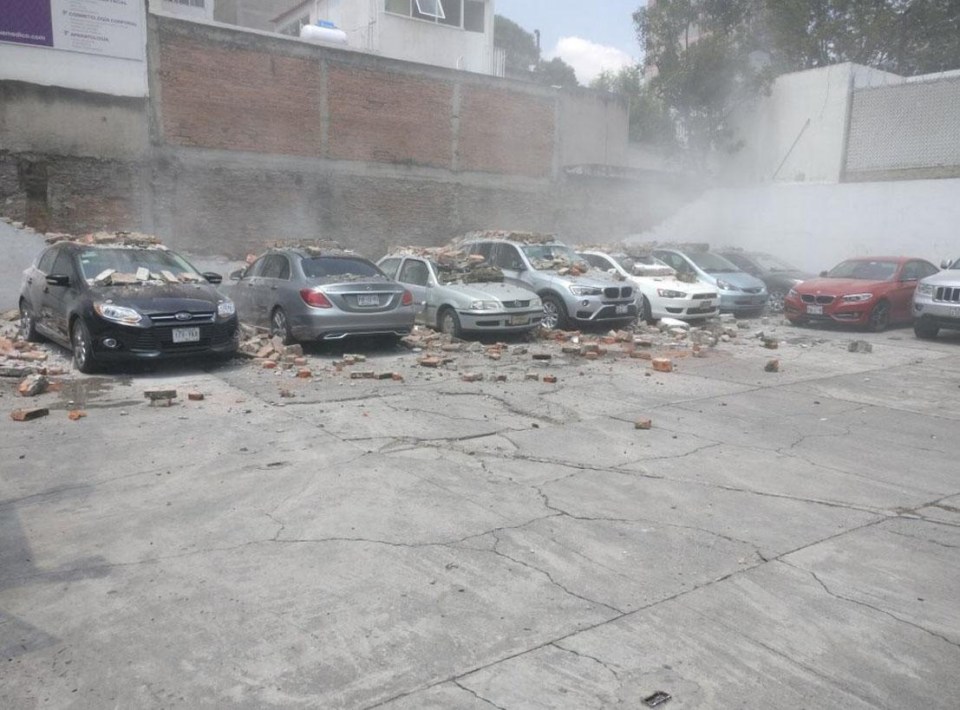 The powerful quake leaves cars covered in debris and the earth cracked 