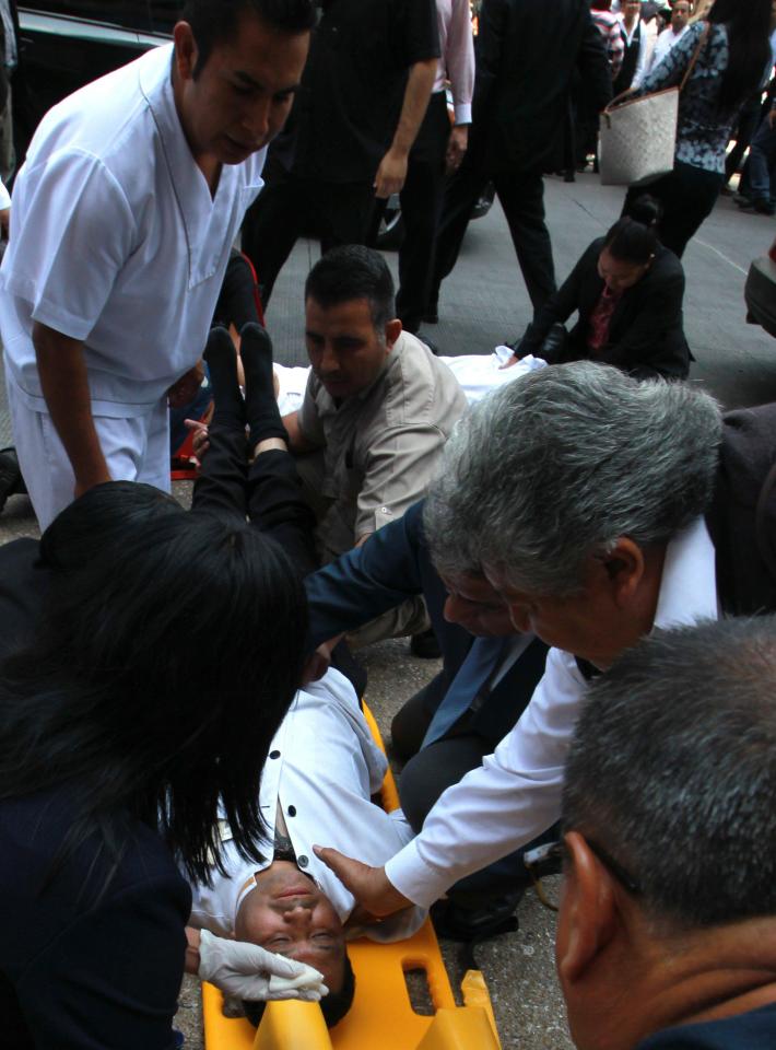  Locals and emergency crew rush to the aid of the injured