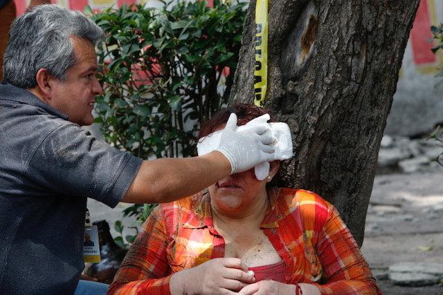 An injured woman being attended to by an emergency worker