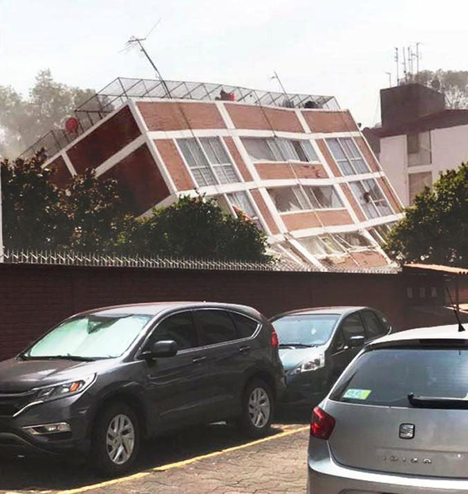 A building caves in due to the sheer impact of the earthquake 