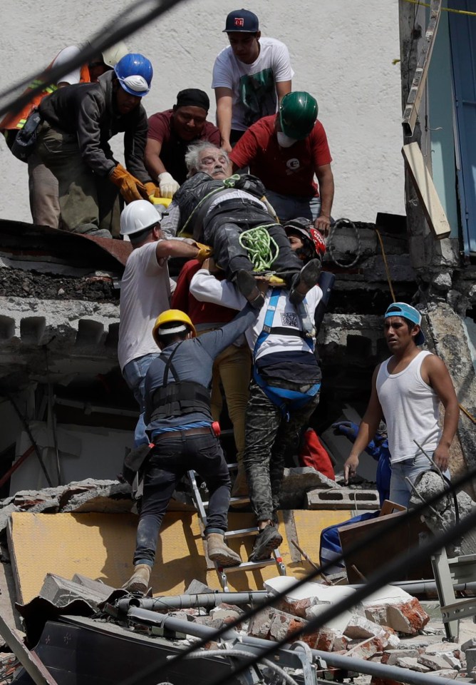 Rescue workers pull an injured man from a collapsed building in the Mexican capital 