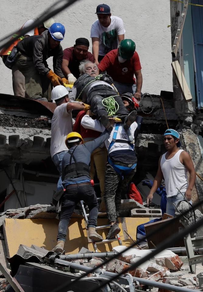  Rescue workers pull an injured man from a collapsed building in the densely populated capital