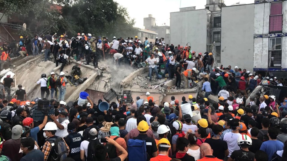 Rescue workers and volunteers attend to the rubble in search for survivors after a 7.1 earthquake hit Mexico