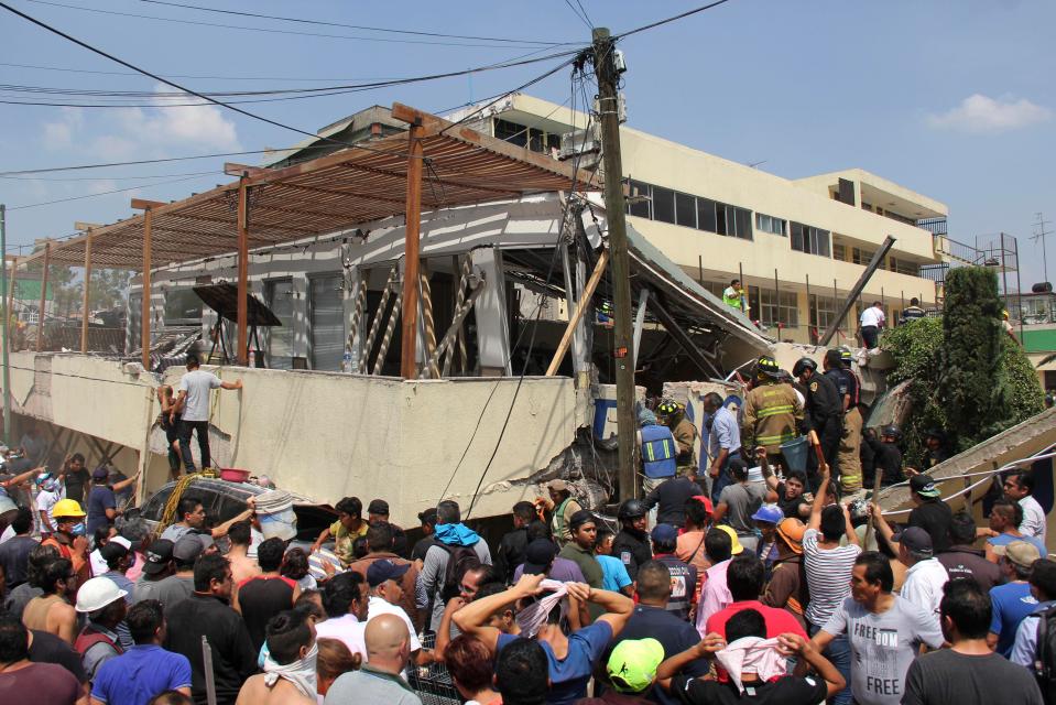  Dozens of volunteers helped to try and find those trapped under the building