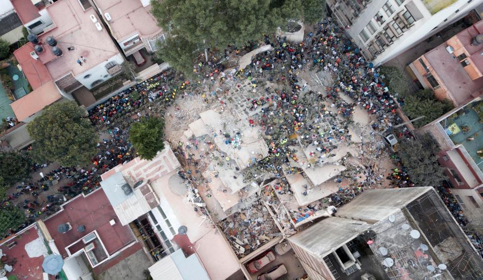  Rescue efforts continue as people desperately try to rescue those trapped under collapsed buildings