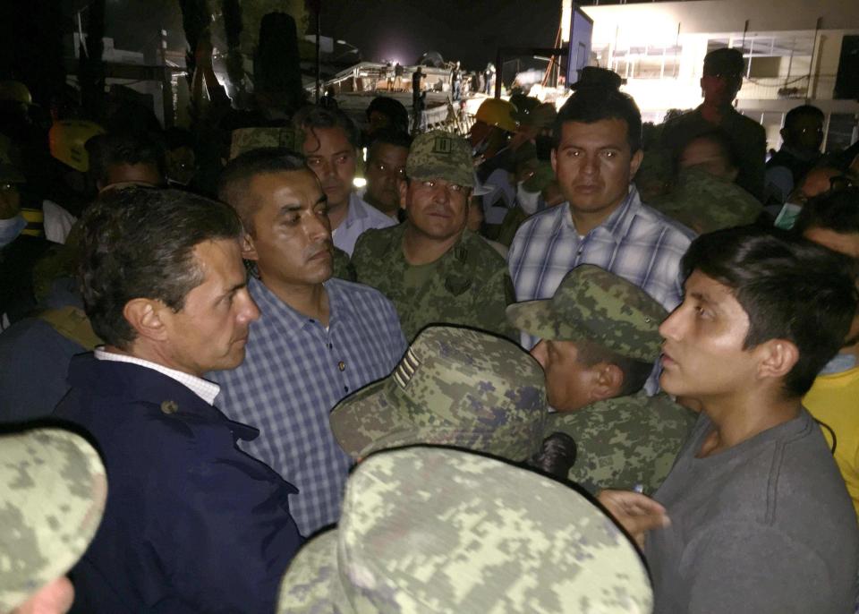  Mexican President Enrique Pena Nieto, left, visits the school in Mexico City