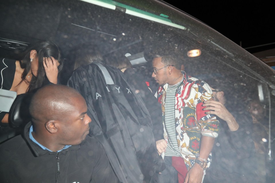 Lewis Hamilton was seen clambering into a car full of models as he left a London nightclub