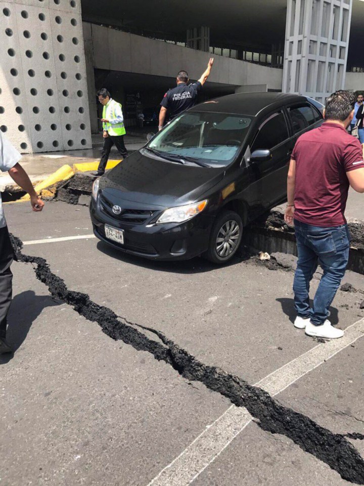 A huge fracture is seen crossing a road in the busy capital city