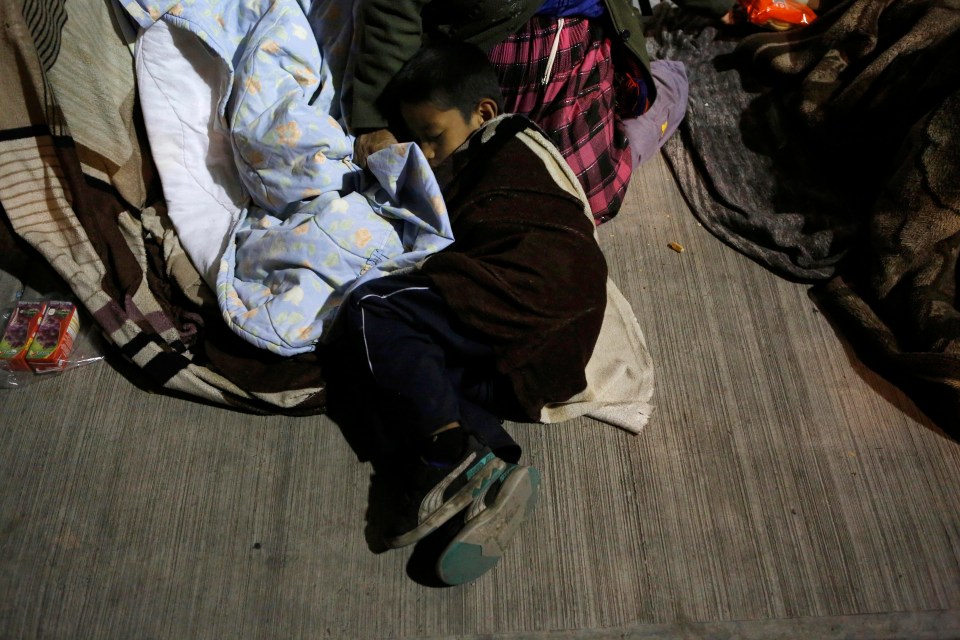 A resident fearing dangerous aftershocks sleeps outside