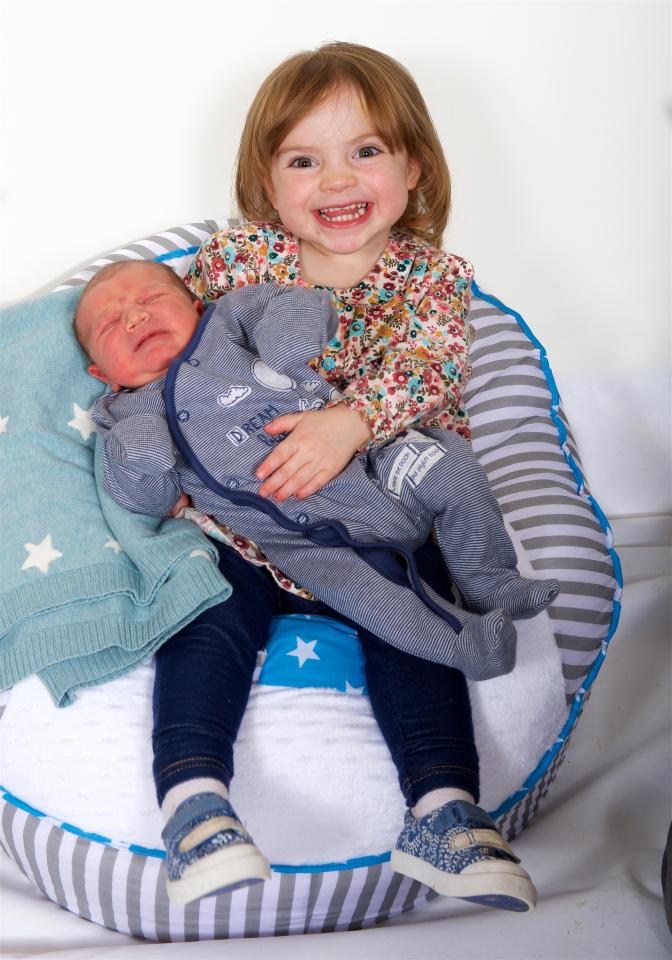  Archie with his one of his big sisters, Hallie, who is only two years old