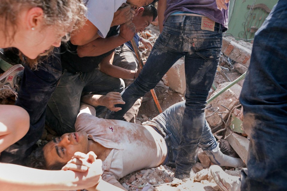 A man is rescued from a collapsed building following Tuesday's devastating earthquake 