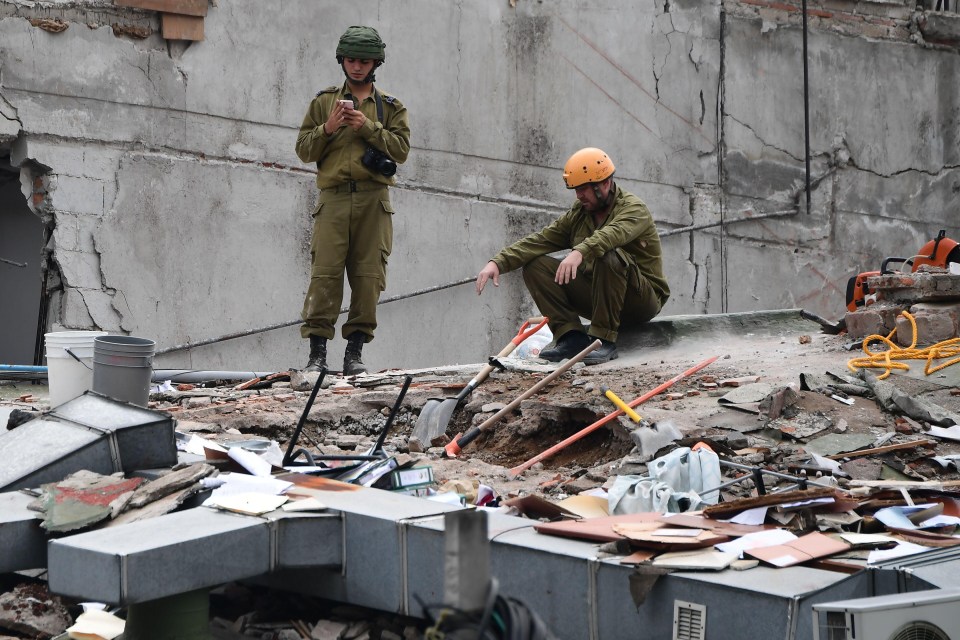 Rescuers from Israel join the search for survivors in a flattened building