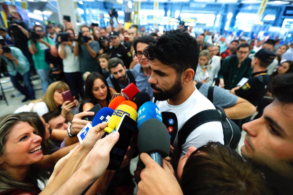  Diego Costa talks to reporters and fans as he arrives at Madrid airport