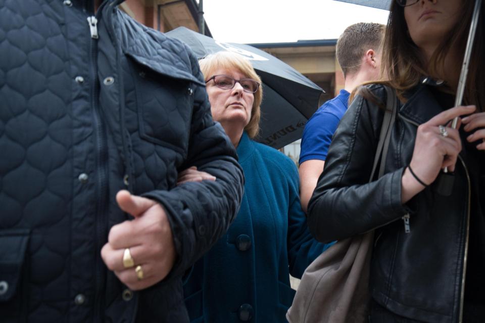  Family members tried to shield Hoey from the cameras using umbrellas at court today