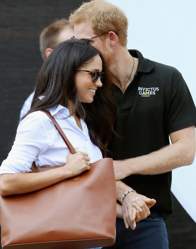  Prince Harry did not shy away from showing his girlfriend attention in public