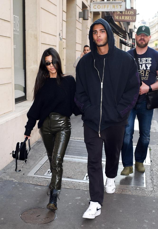  Kourtney Kardashian and boyfriend Younes Bendjima have returned to Paris Fashion Week a year after Kim was robbed at gunpoint