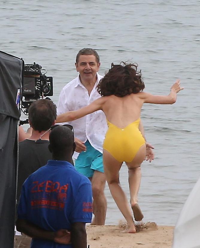 She is seen running towards co-star Rowan Atkinson