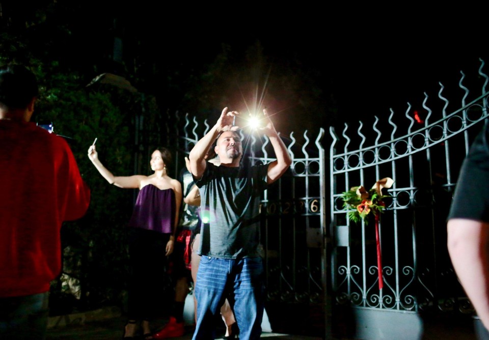 Fans gather at the gate of the Playboy Mansion in Los Angeles, California, last night