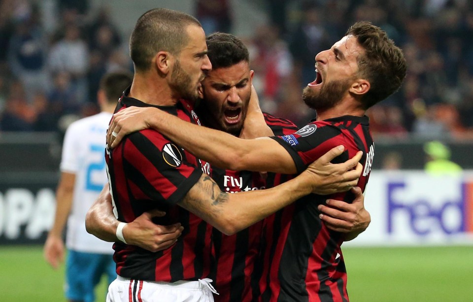 The striker celebrates with his team-mates after proving to be the hero at the San Siro