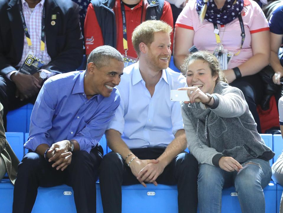  A woman takes a selfie with Barack Obama and Prince Harry during the wheelchair basketball at the Pan Am Sports Centre