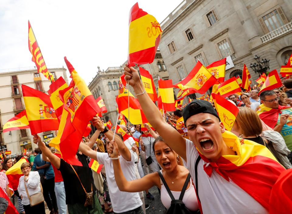  People shout and hold up Spanish flags during a demonstration in favour of a unified Spain in Barcelona, Spain