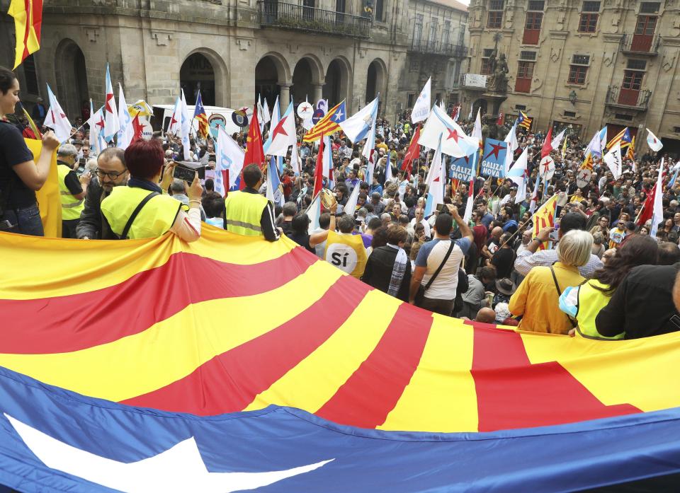  People unfurl the Catalan pro-independence flag during a protest called by the organisation 'Galicia with Catalonia'