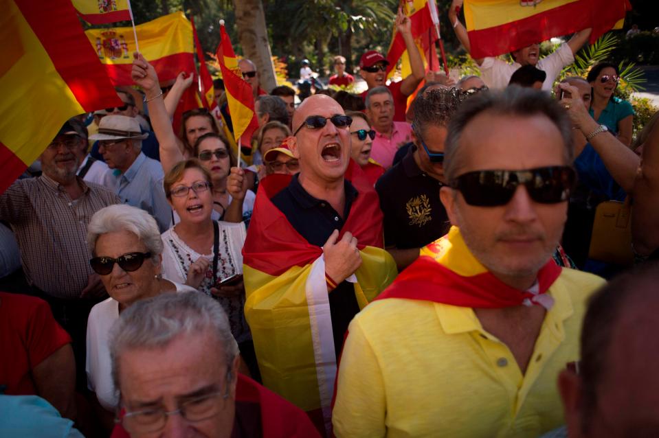  People hold Spanish flags during a demonstration against independence in Malaga