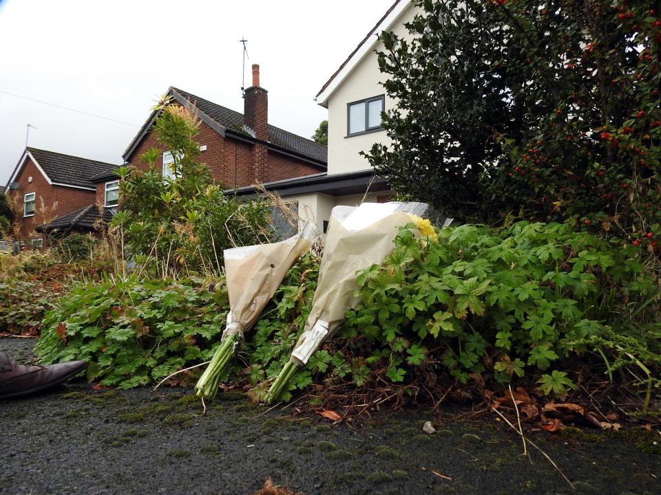  Floral tributes were laid outside the house as forensics teams scoured for evidence