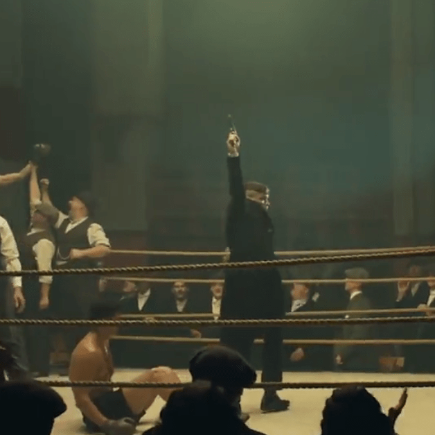 Tommy fires his pistol into the air in the middle of a boxing ring