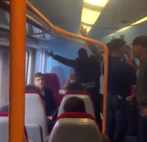 The men were seen chanting a Reading FC song as smoke filled the carriage