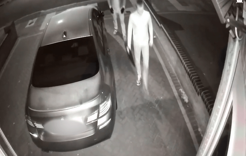 The men can be seen walking up to the car parked in the driveway - with police warning of a spate of similar thefts