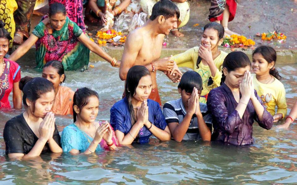  Brother and sister devotees offer prayer after taking holy dip in river Yamuna on the occasion of Yam Dutiya popularly know as Bhai Dooj festival