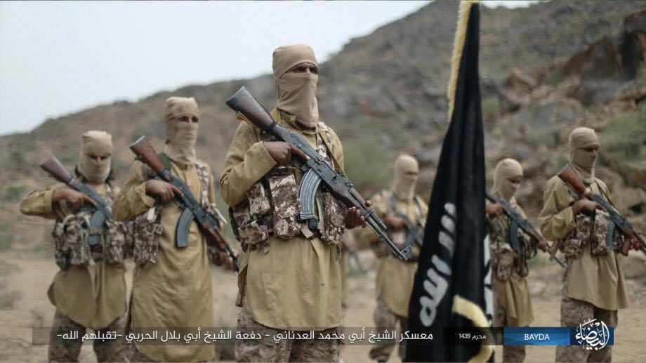 The trainees pictured with the sinister black flag of ISIS