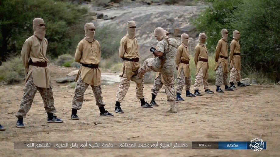 The ISIS instructor kicks one of his trainees between the legs. The terror group released the pic as propaganda